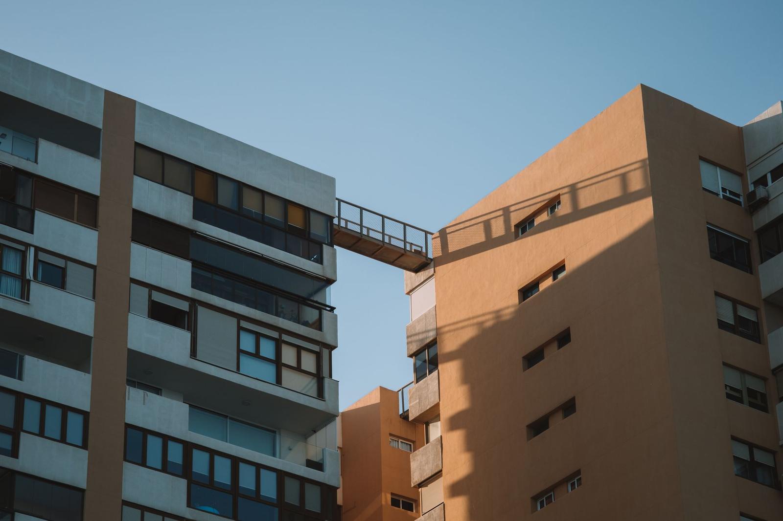 Bridge Between Buildings Against Blue Sky